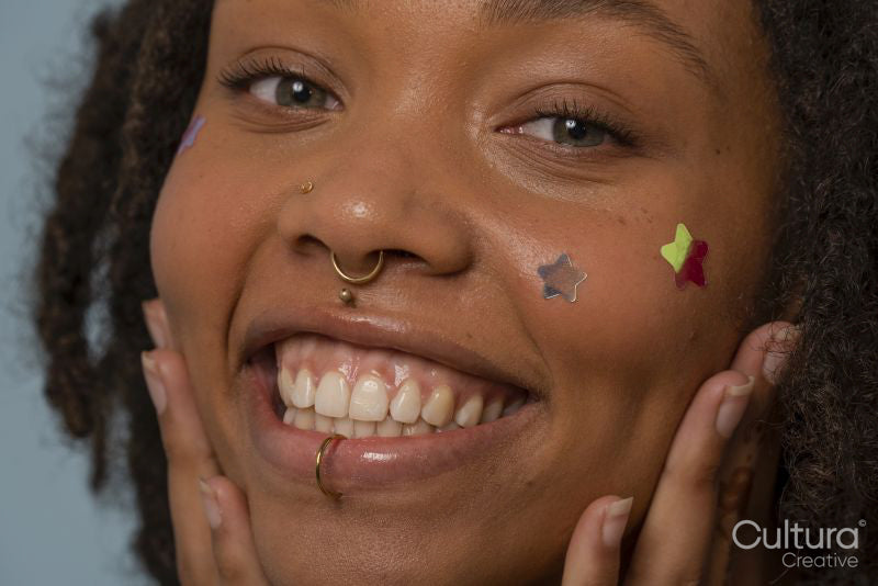 Portrait of young woman wearing star stickers on face