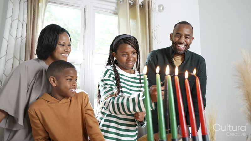 Family with children lighting kinara candles