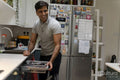 Man putting dishes into dishwasher