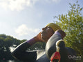 Woman in wetsuit putting on swimming cap