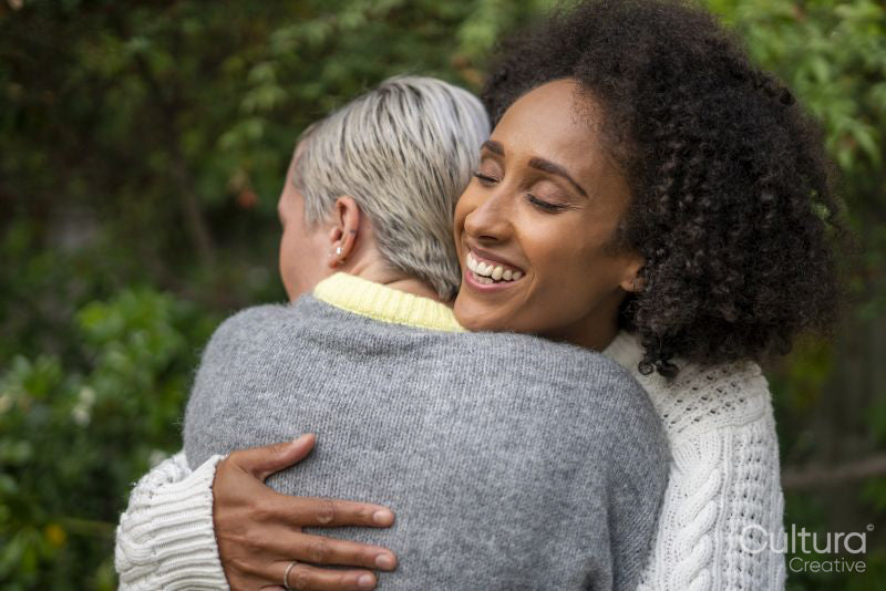 Smiling couple embracing in garden
