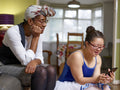 Mother and daughter with Down syndrome using smart phone