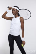 Studio portrait of athletic woman with tennis racket and ball