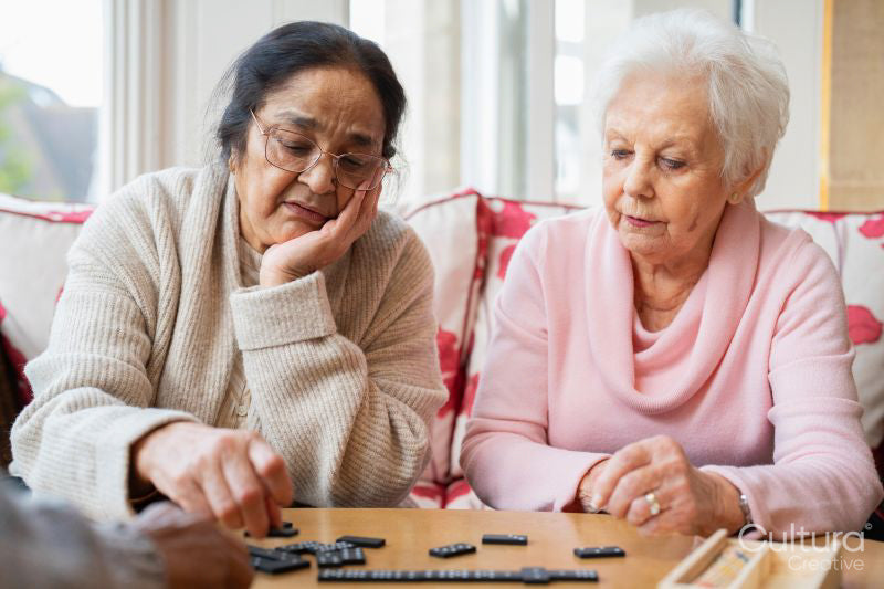 Senior women playing domino in nursing home