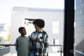 Smiling mother and son standing on balcony