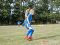 Girl dressed in uniform practicing on soccer field