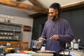 Smiling man cooking meal in kitchen
