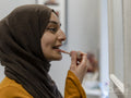 Woman applying lipstick