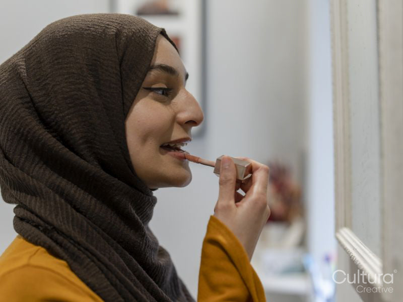 Woman applying lipstick