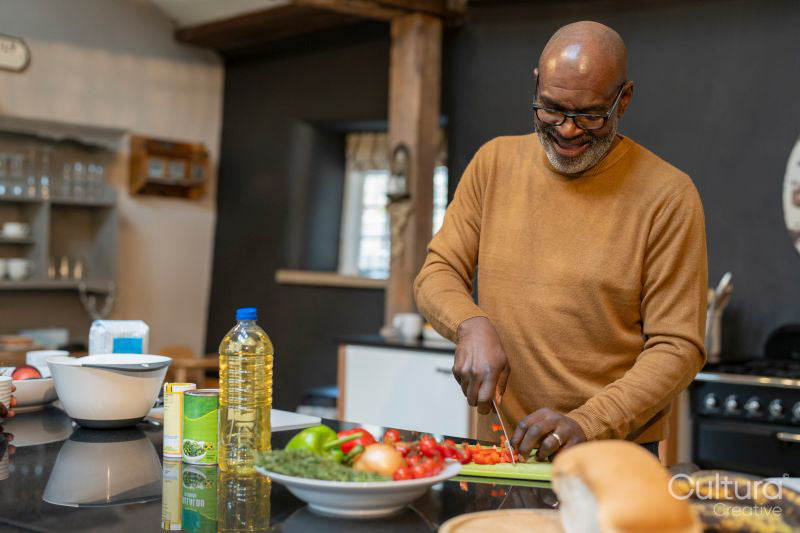 Senior man preparing meal in kitchen