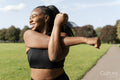 Young woman stretching in park