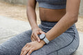 Sporty woman checking time on wristwatch