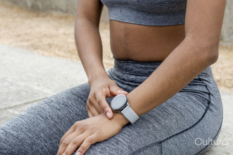 Sporty woman checking time on wristwatch