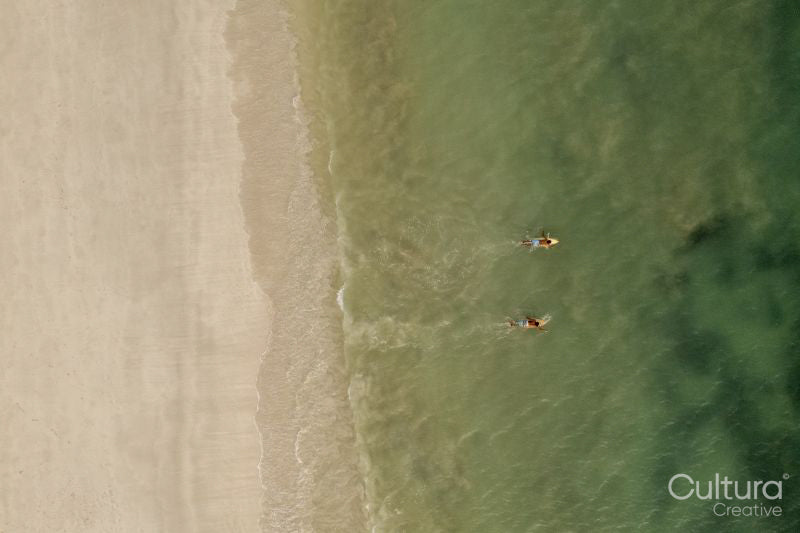 Indonesia, Lombok, Aerial view of men surfing in sea