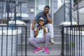 Portrait of father and daughter sitting on porch
