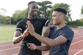 Portrait of two athletes doing high five