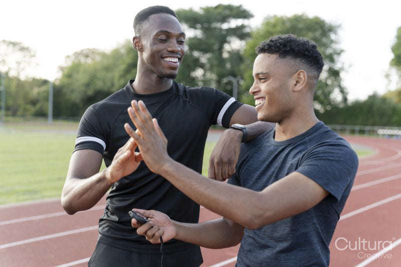 Portrait of two athletes doing high five