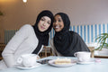 Portrait of young female friends meeting in cafe