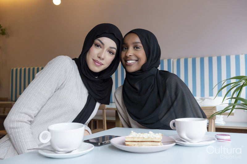 Portrait of young female friends meeting in cafe