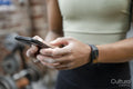 Woman using smart phone on gym