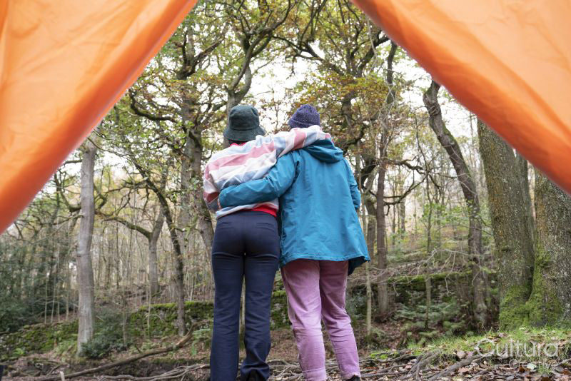 Female friends camping in forest