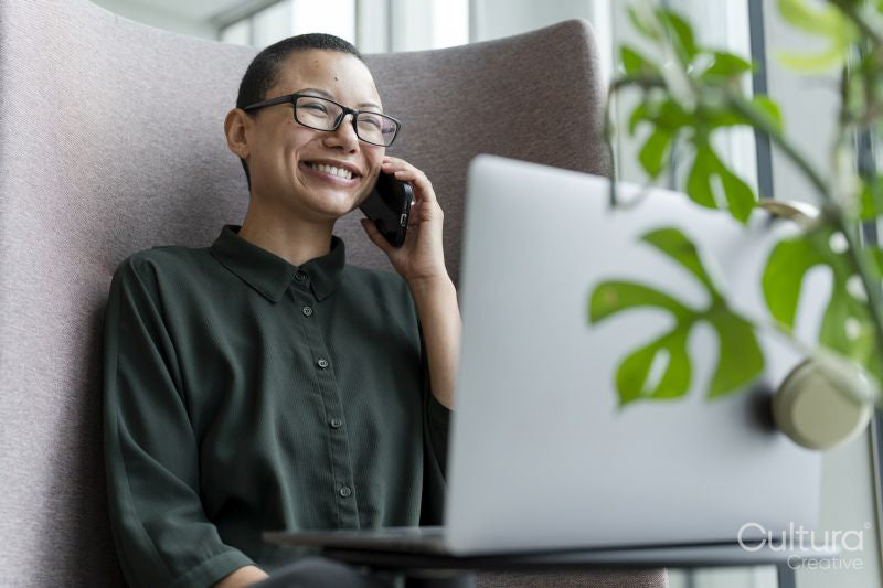 Non binary office worker resting in office lobby