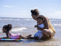 Mother with children playing in sea