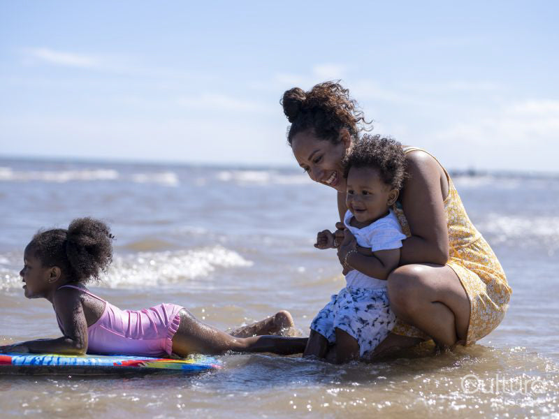Mother with children playing in sea