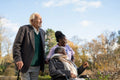 Senior people accompanied by nurse going on walk in park