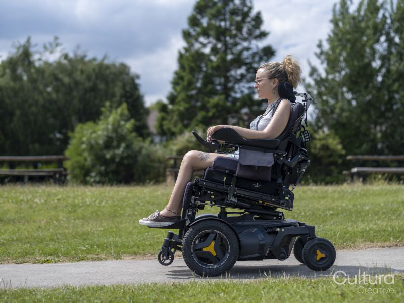 Woman in electric wheelchair going on walk
