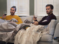 couple relaxing on sofa at home