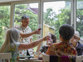 Family toasting with red wine at dinner table