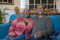 Senior couple sitting on sofa and laughing