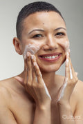 Portrait of smiling woman washing face