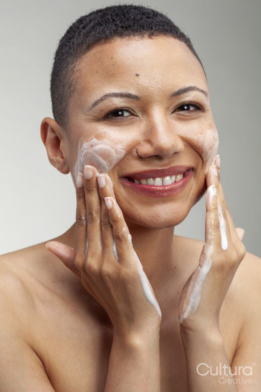 Portrait of smiling woman washing face