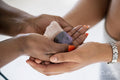 Close-up of women''s hands holding crystals