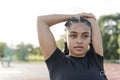 Female athlete stretching arms before training