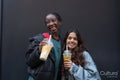 Portrait of two cheerful women drinking bubble tea