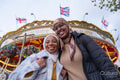 Portrait of female tourists in hijabs in front of merry-go-round