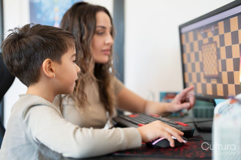 Mother and son playing chess on computer