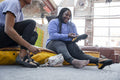 Mother and daughter putting on climbing shoes while sitting on mattress