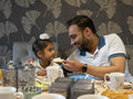 Father and son eating meal at home