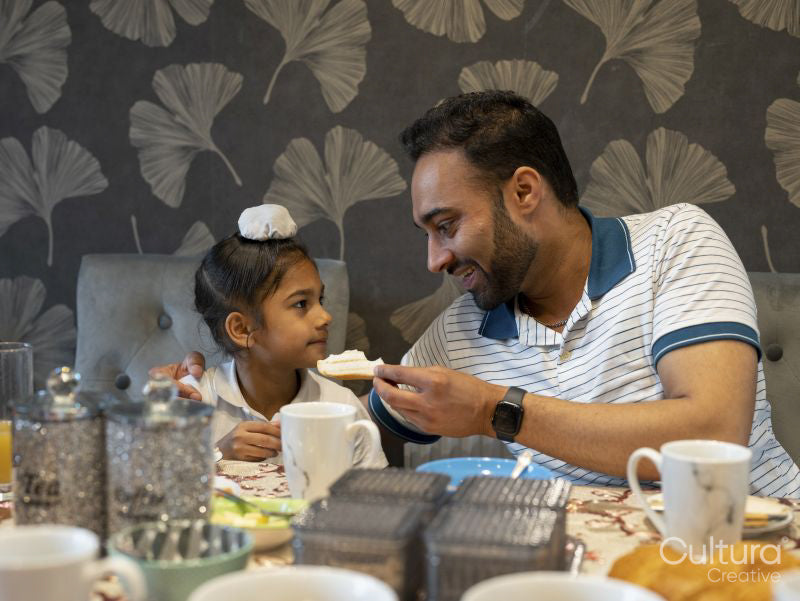 Father and son eating meal at home
