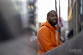 South Yorkshire, Smiling man in orange hooded shirt in city