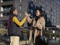Two young women meeting in street