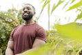 Portrait of smiling man standing in urban vegetable garden