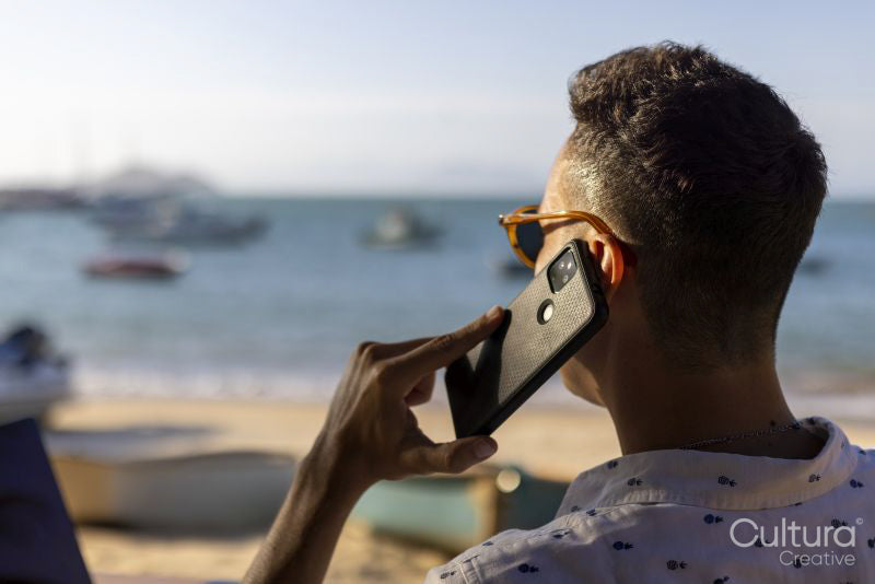 Man using smart phone on beach