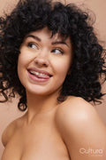 Studio portrait of beautiful woman with curly hair and freckles