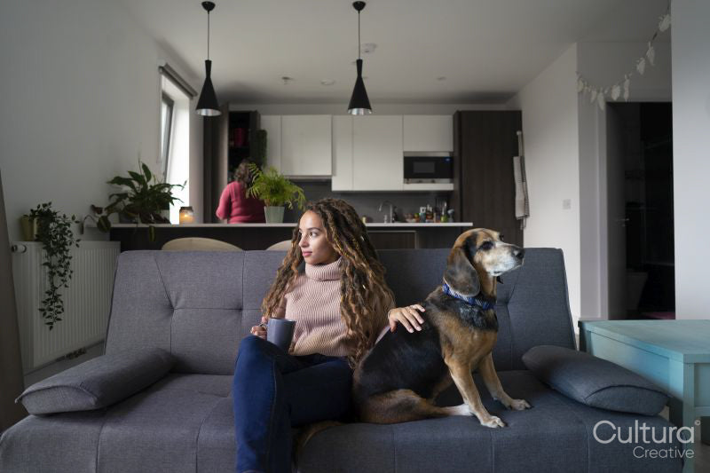 Young woman and dog relaxing in living room