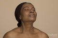 Studio shot of mature woman with braided hair and eyes closed